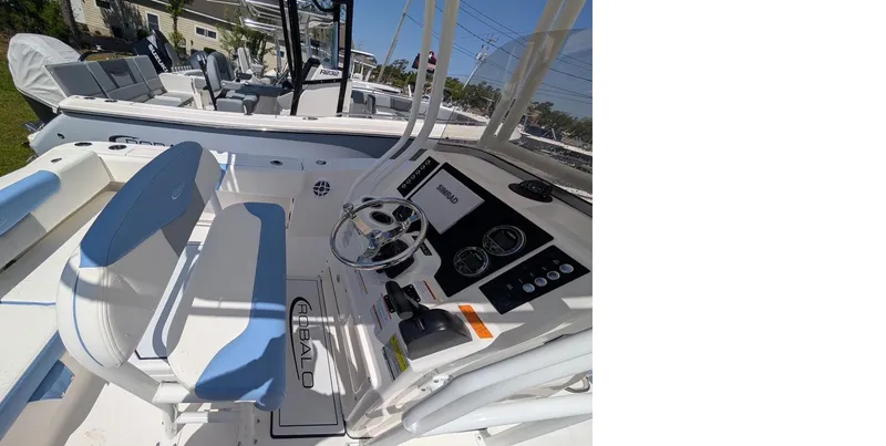 Slide: The Image of 2025 Robalo R202 Explorer boat interior with steering console and seating. - 15