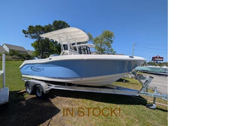 Slide: The Image of 2025 Robalo R202 Explorer boat on trailer, in stock, displayed outdoors. - 17