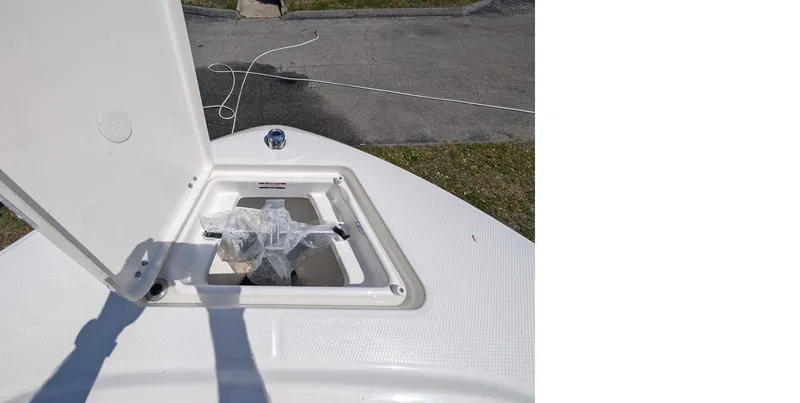 Slide: The Image of 2025 Robalo R202 Explorer boat storage compartment open on deck. - 7