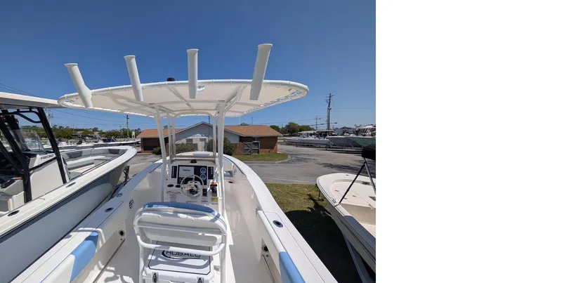 Slide: The Image of 2025 Robalo R202 Explorer boat with T-top and helm, parked outdoors. - 8