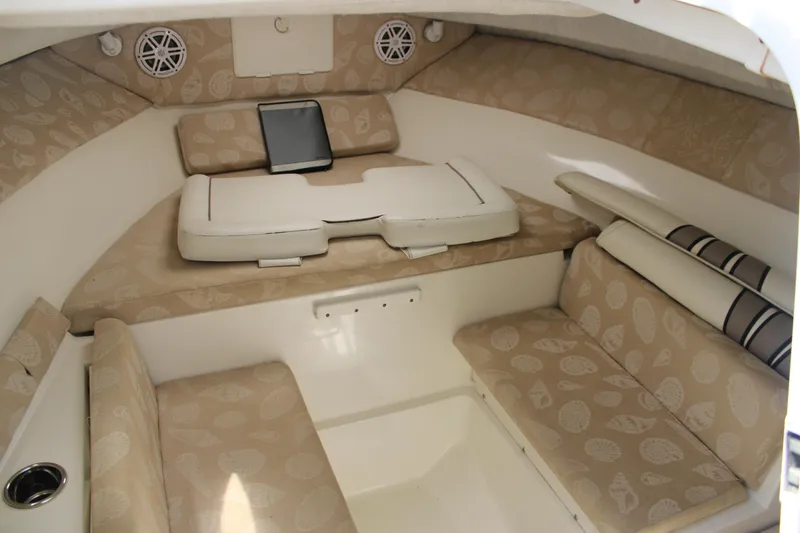Slide: The Image of 2001 Wellcraft 230 Coastal cabin interior with beige seating and storage. - 14