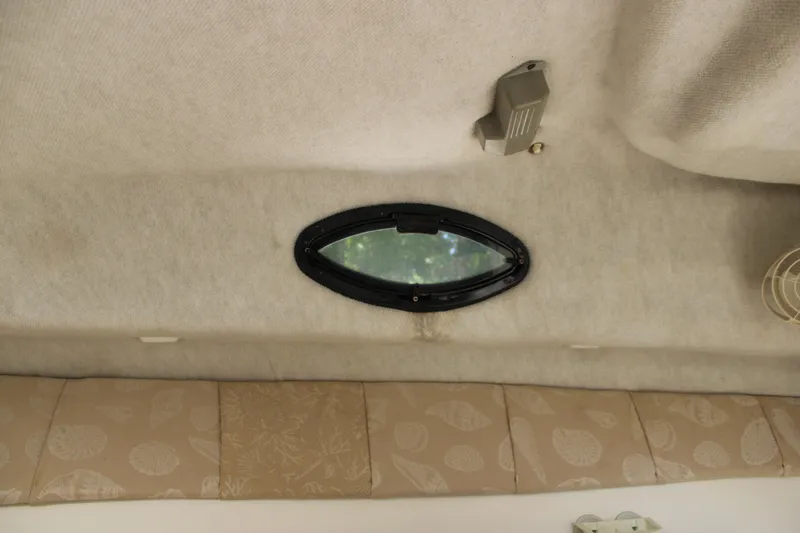 Slide: The Image of Interior view of 2001 Wellcraft 230 Coastal boat cabin with oval window. - 17