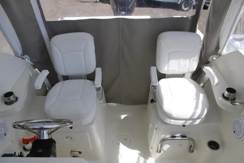 Slide: The Image of Interior of a 2001 Wellcraft 230 Coastal boat with two white captain's chairs. - 8