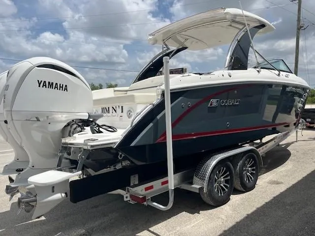Slide: The Image of 2022 Cobalt 30SC boat on trailer with Yamaha engine, parked outdoors. - 3
