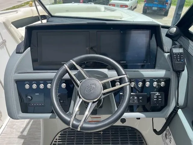 Slide: The Image of 2022 Cobalt 30SC boat dashboard with dual screens and steering wheel. - 5
