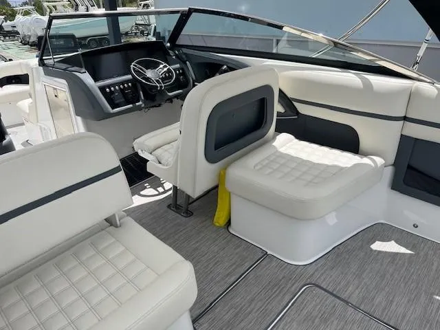Slide: The Image of 2022 Cobalt 30SC boat interior with white seating and modern dashboard. - 9