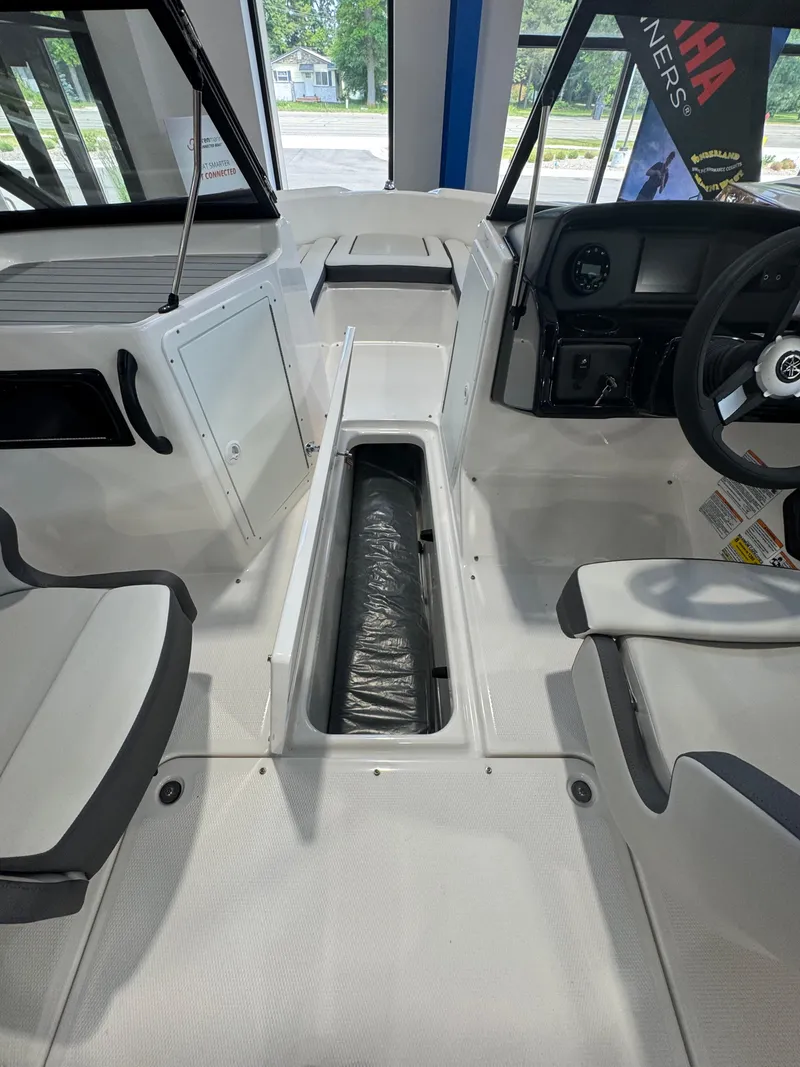 Slide: The Image of 2025 Yamaha Boats SX190 interior with seating and storage compartment. - 11
