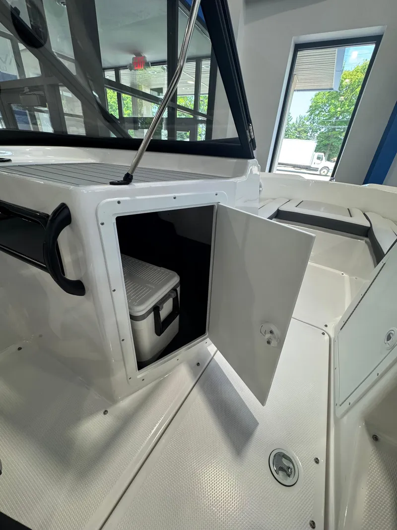 Slide: The Image of 2025 Yamaha Boats SX190 interior with open storage compartment and visible cooler. - 8