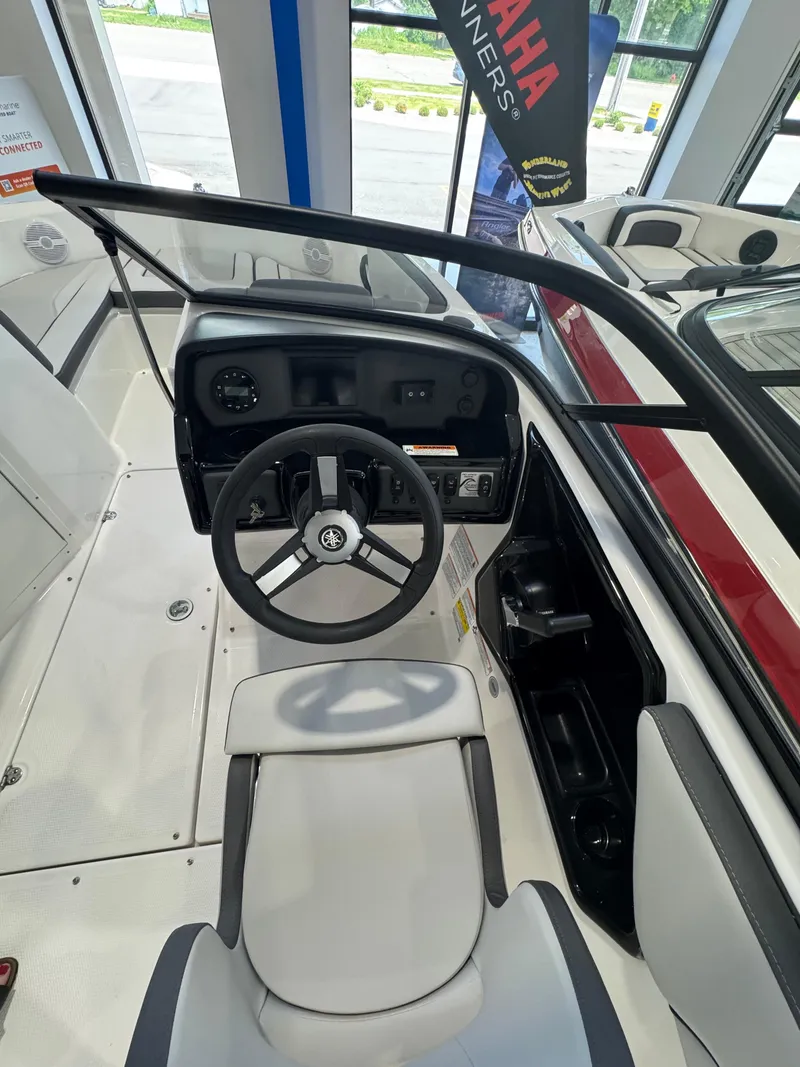 Slide: The Image of 2025 Yamaha Boats SX190 cockpit with steering wheel and dashboard in showroom. - 9