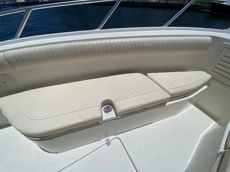 Slide: The Image of 2014 Mako 284 CC boat with cushioned seating and stainless steel railing. - 10