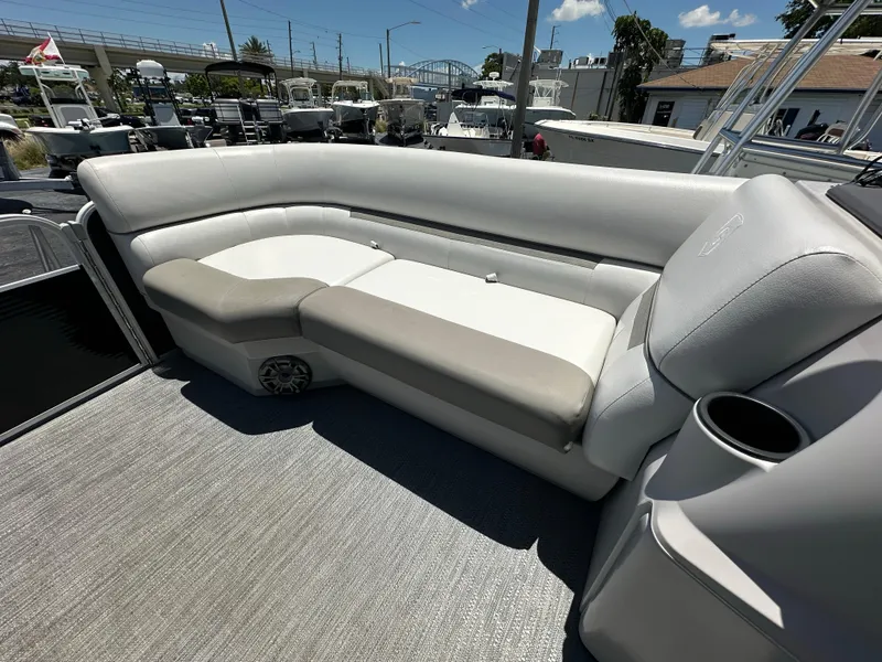 Slide: The Image of 2022 Godfrey Sweetwater 2286 FS boat interior with gray seating and cup holder. - 10