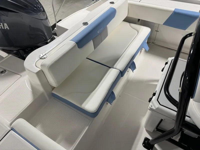 Slide: The Image of 2025 Robalo R202 Explorer boat interior with cushioned seating and Yamaha engine. - 12
