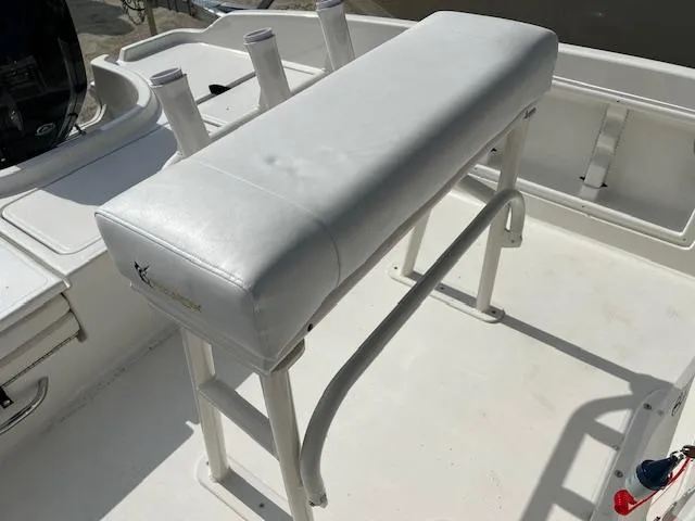 Slide: The Image of 2024 Bayliner Trophy T18Bay boat with white cushioned seating and rod holders. - 3
