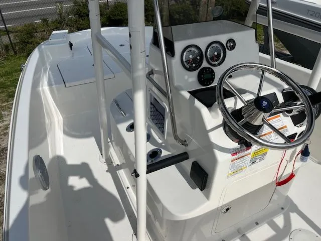 Slide: The Image of 2024 Bayliner Trophy T18Bay boat cockpit with steering wheel and instrument panel. - 6