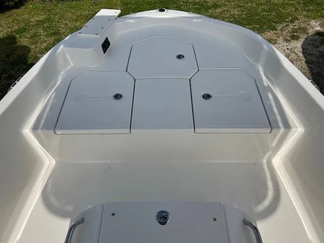 Slide: The Image of 2024 Bayliner Trophy T18Bay boat deck, featuring spacious storage compartments. - 8