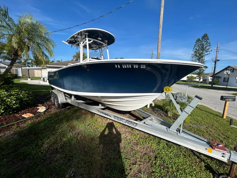 The Image of 2017 Sportsman Heritage 231 Center Console boat on trailer, parked outdoors. - 0
