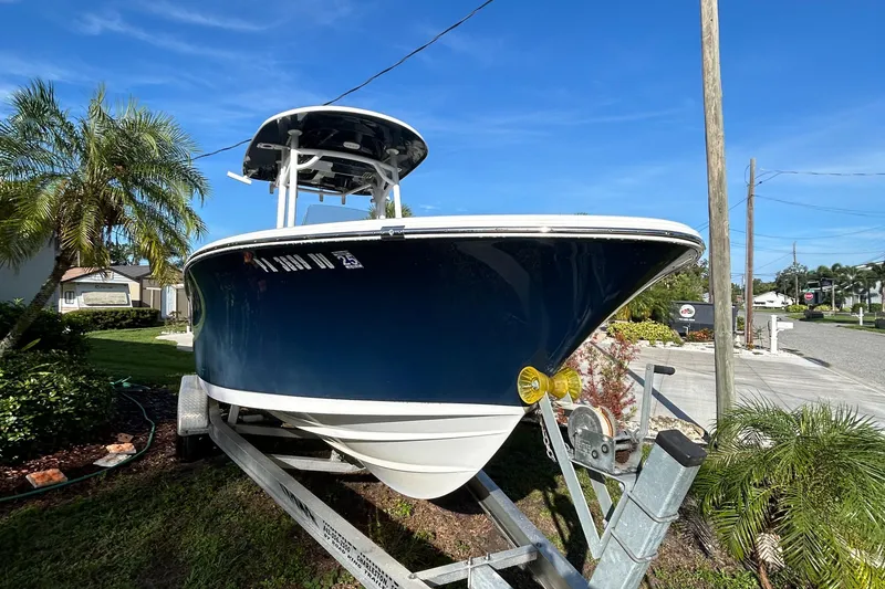 Slide: The Image of 2017 Sportsman Heritage 231 Center Console boat on trailer, parked outdoors. - 11