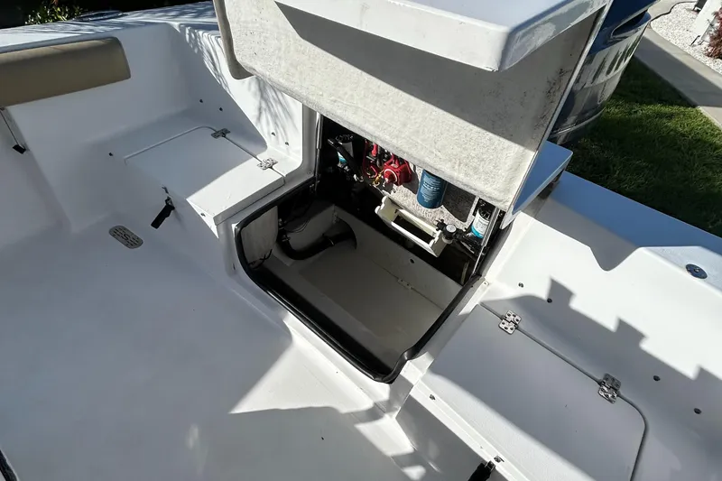 Slide: The Image of 2017 Sportsman Heritage 231 Center Console boat with open storage compartment. - 12