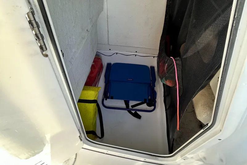 Slide: The Image of Storage compartment in 2017 Sportsman Heritage 231 Center Console boat with gear and equipment. - 14