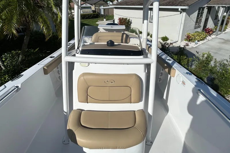 Slide: The Image of 2017 Sportsman Heritage 231 Center Console boat with tan seating and white frame. - 15