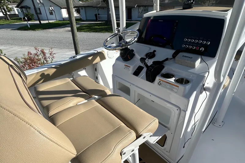 Slide: The Image of 2017 Sportsman Heritage 231 Center Console with beige seating and modern dashboard controls. - 17