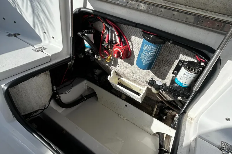 Slide: The Image of 2017 Sportsman Heritage 231 Center Console boat's engine compartment with wiring and filters. - 21