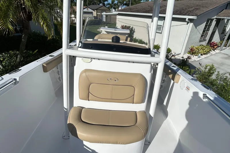 Slide: The Image of 2017 Sportsman Heritage 231 Center Console boat with tan seating, parked in residential area. - 24