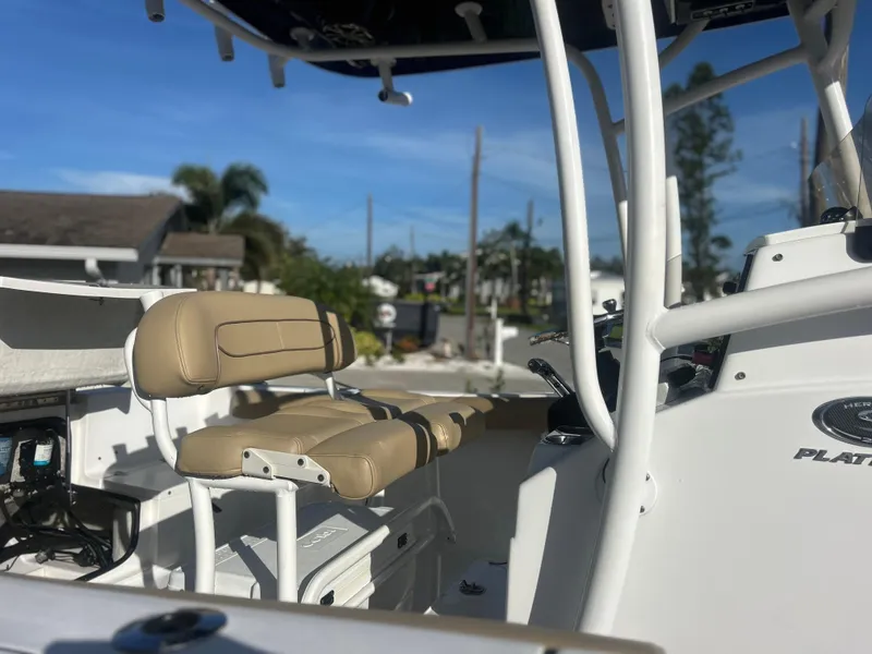 Slide: The Image of 2017 Sportsman Heritage 231 Center Console boat with beige seating and control panel. - 7