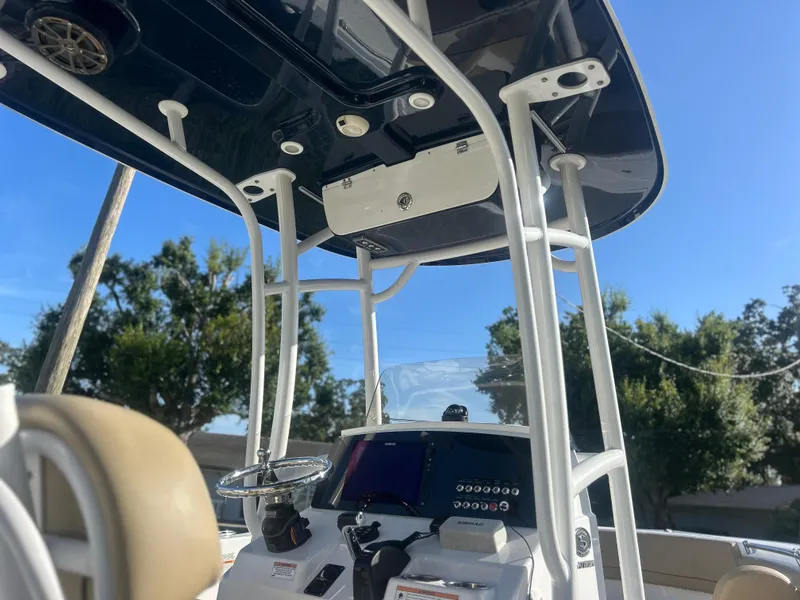 Slide: The Image of 2017 Sportsman Heritage 231 Center Console boat interior with steering wheel and control panel. - 8