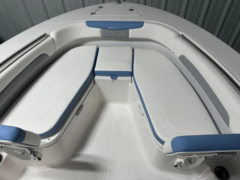 Slide: The Image of 2025 Robalo R202 Explorer boat interior with white and blue cushioned seating. - 5