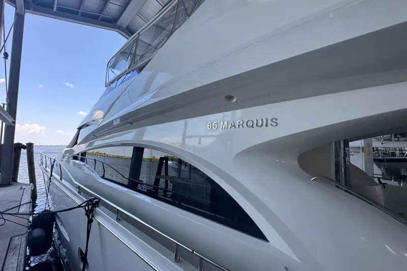 Slide: The Image of Luxury 2006 Marquis 65 yacht docked under a covered marina. - 12