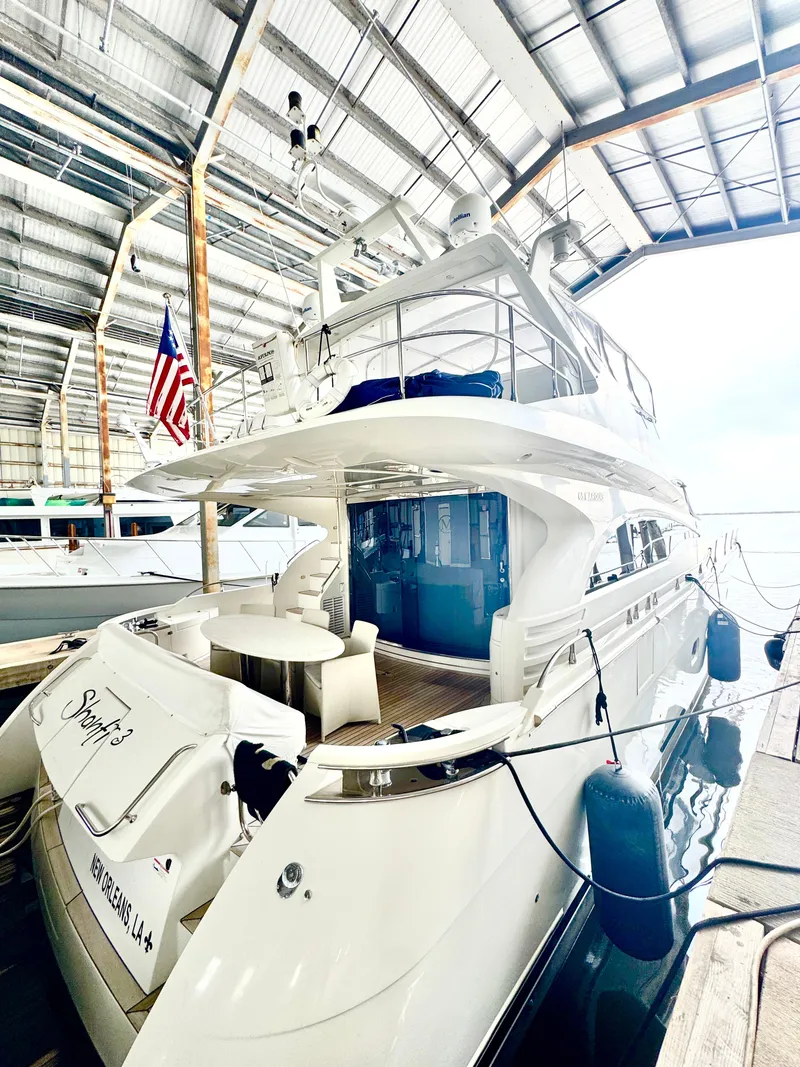 Slide: The Image of Luxury 2006 Marquis 65 yacht docked in a covered marina. - 14