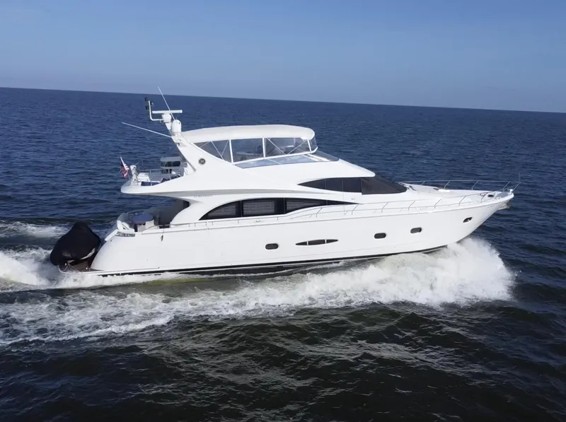 Slide: The Image of 2006 Marquis 65 yacht cruising on open water, side view. - 2