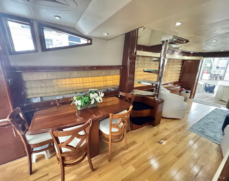 Slide: The Image of Luxurious interior of a 2006 Marquis 65 yacht with elegant dining area and wooden flooring. - 22