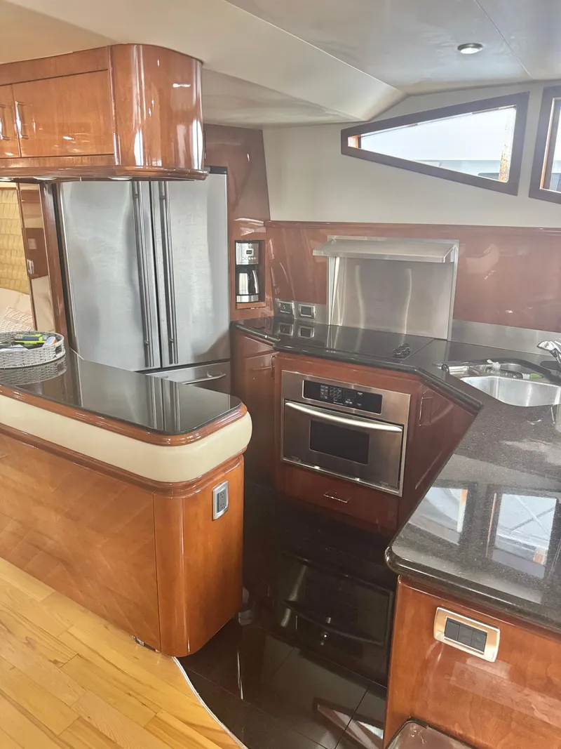 Slide: The Image of Luxurious kitchen interior of a 2006 Marquis 65 yacht with modern appliances. - 27
