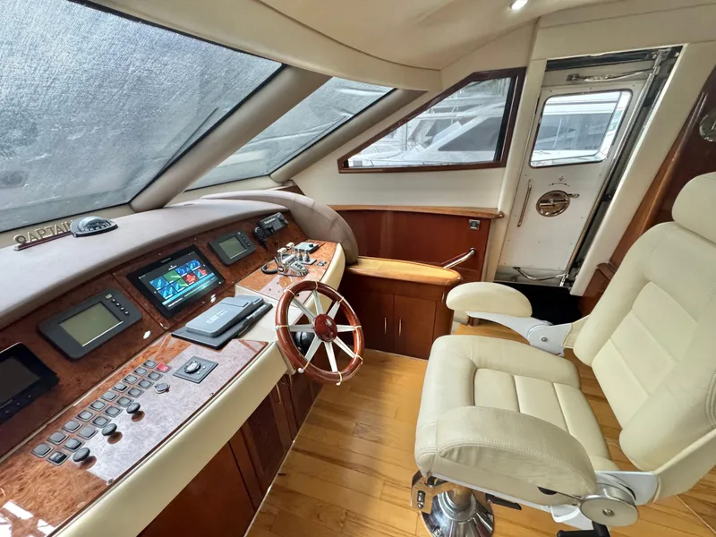 Slide: The Image of Luxurious 2006 Marquis 65 yacht helm with leather chair and advanced navigation controls. - 28