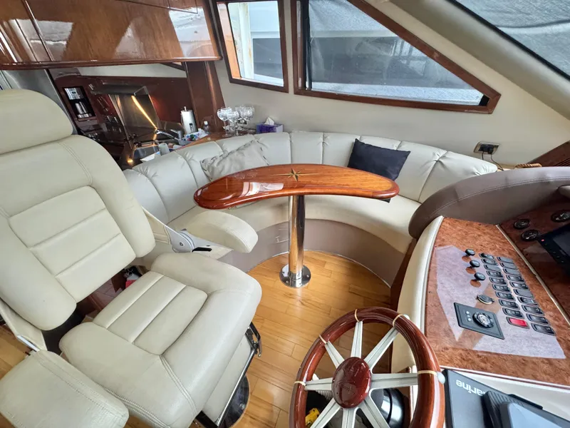 Slide: The Image of Luxurious interior of a 2006 Marquis 65 yacht with plush seating and elegant wood finishes. - 29