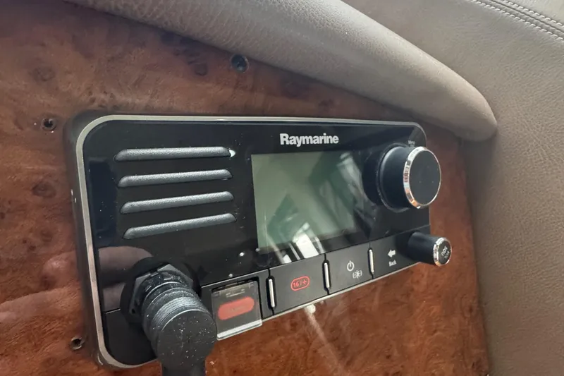 Slide: The Image of Raymarine control panel in 2006 Marquis 65 yacht, featuring knobs and buttons. - 33