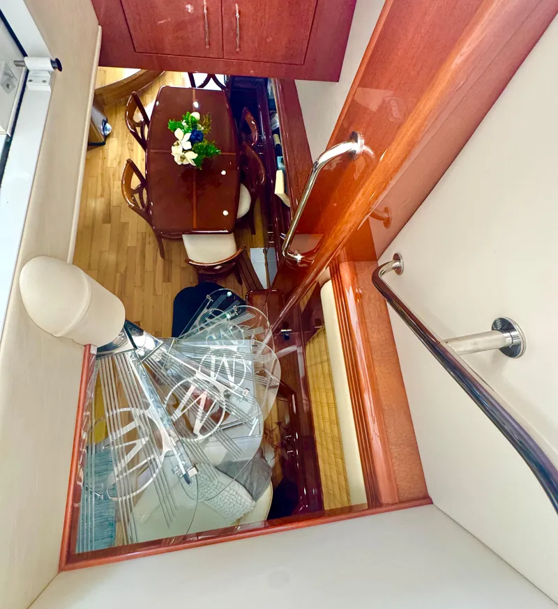 Slide: The Image of Interior view of 2006 Marquis 65 yacht, featuring elegant dining area and wooden finishes. - 37