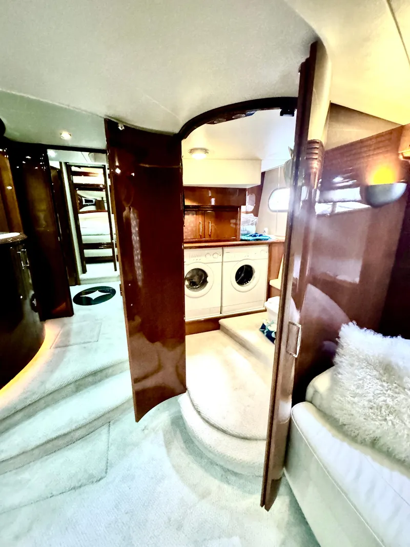 Slide: The Image of Interior of a 2006 Marquis 65 yacht featuring a laundry area and luxurious furnishings. - 45