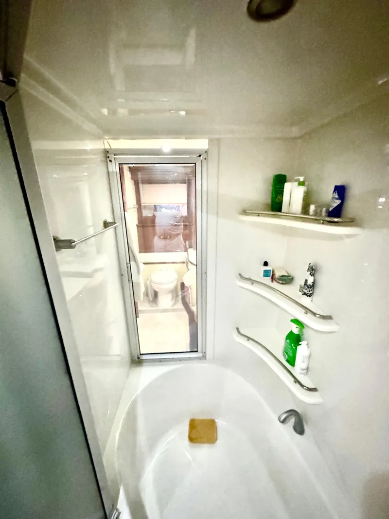 Slide: The Image of Luxurious bathroom in 2006 Marquis 65 yacht with modern fixtures and ample storage. - 48