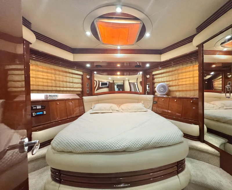 Slide: The Image of Luxurious 2006 Marquis 65 yacht bedroom with elegant wood finishes and ambient lighting. - 50