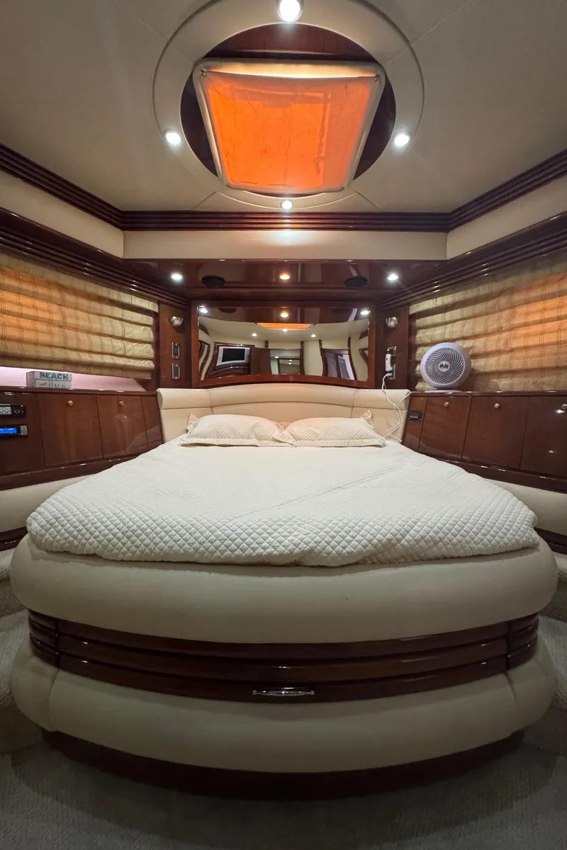 Slide: The Image of Luxurious 2006 Marquis 65 yacht bedroom with elegant wood finishes and ambient lighting. - 51