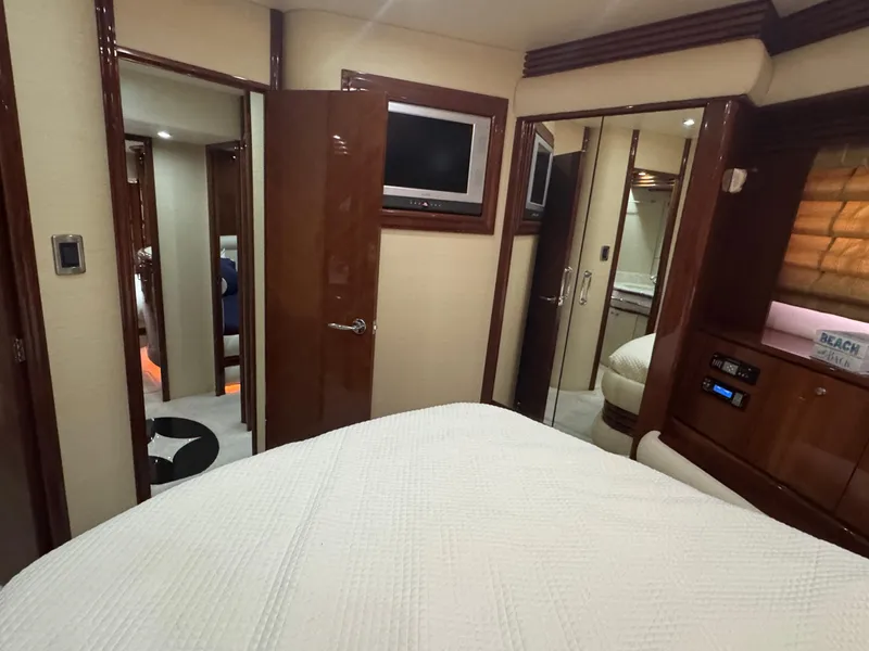 Slide: The Image of Luxurious interior of a 2006 Marquis 65 yacht bedroom with modern amenities. - 52