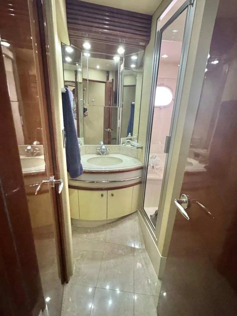 Slide: The Image of Luxurious bathroom in 2006 Marquis 65 yacht with modern fixtures and elegant design. - 53