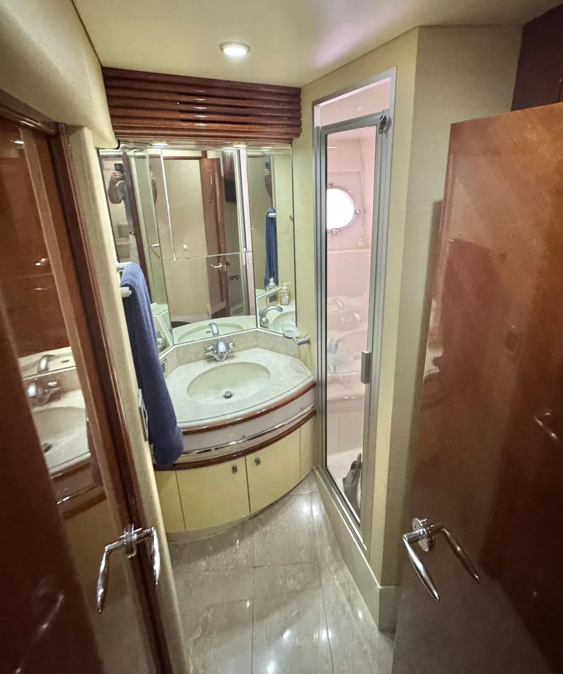 Slide: The Image of Luxurious bathroom in a 2006 Marquis 65 yacht with modern fixtures and elegant design. - 57