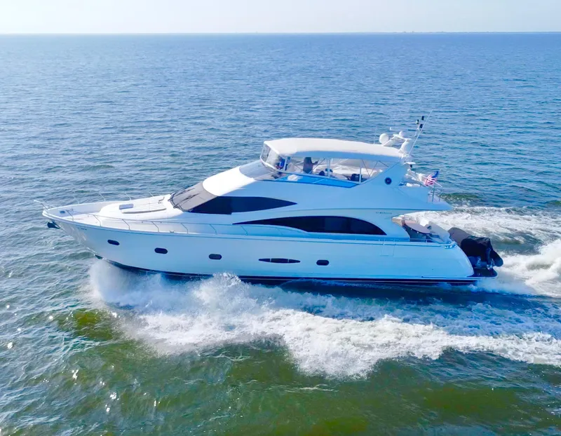 Slide: The Image of Luxury 2006 Marquis 65 yacht cruising on open sea under clear skies. - 6
