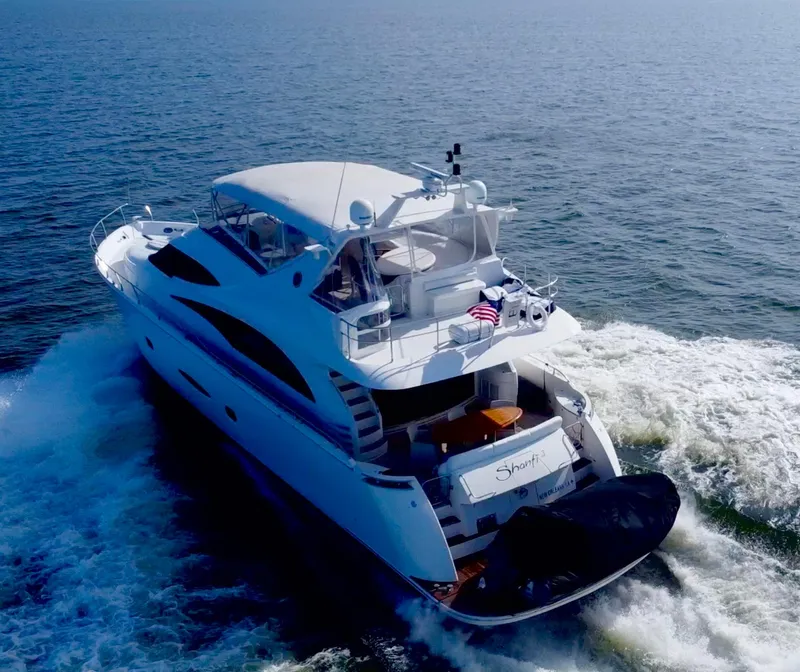 Slide: The Image of Luxurious 2006 Marquis 65 yacht cruising on open water, rear view. - 7