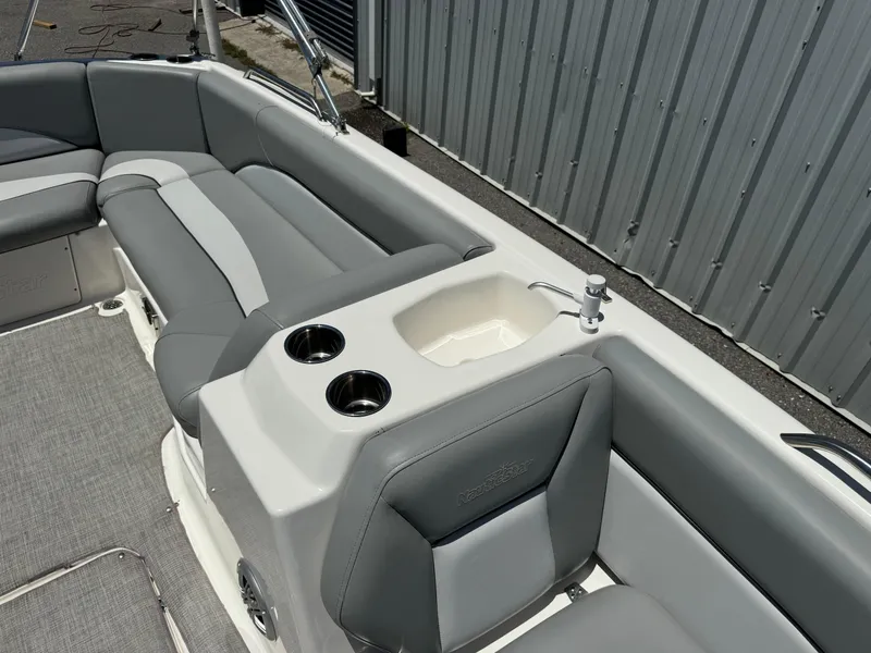 Slide: The Image of 2022 NauticStar 193SC boat interior with gray seating and built-in cup holders. - 10