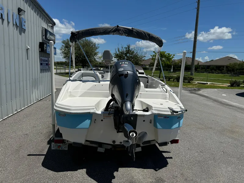 Slide: The Image of 2022 NauticStar 193SC boat with outboard motor, parked outdoors on a sunny day. - 15